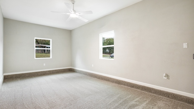 empty room with ceiling fan and carpet floors