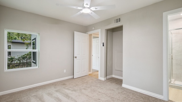 unfurnished bedroom with light colored carpet and ceiling fan