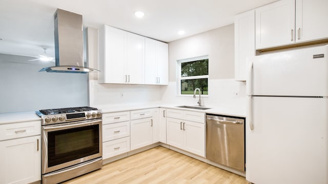 kitchen featuring white cabinets, stainless steel appliances, sink, and range hood