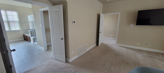 corridor featuring light tile patterned flooring