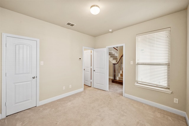 unfurnished bedroom with light carpet