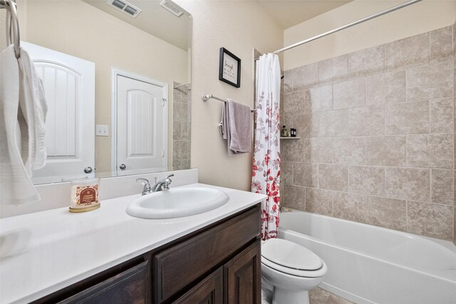 full bathroom with vanity, toilet, and shower / bath combo with shower curtain