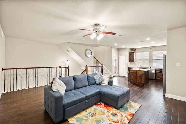 living room featuring dark hardwood / wood-style flooring and ceiling fan