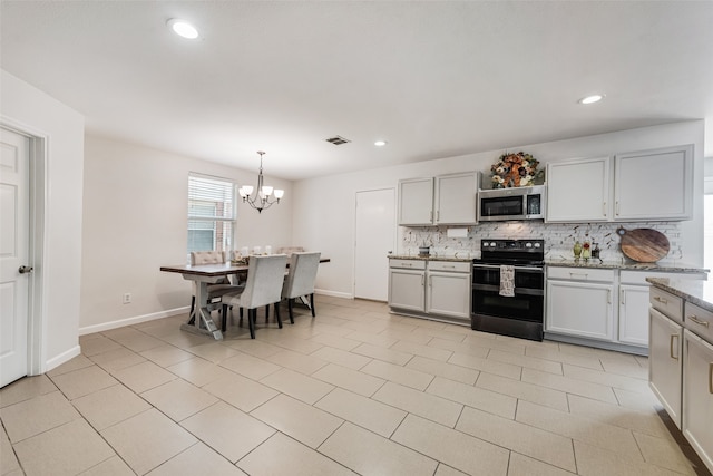 kitchen with decorative backsplash, black range with electric cooktop, light stone countertops, a notable chandelier, and pendant lighting