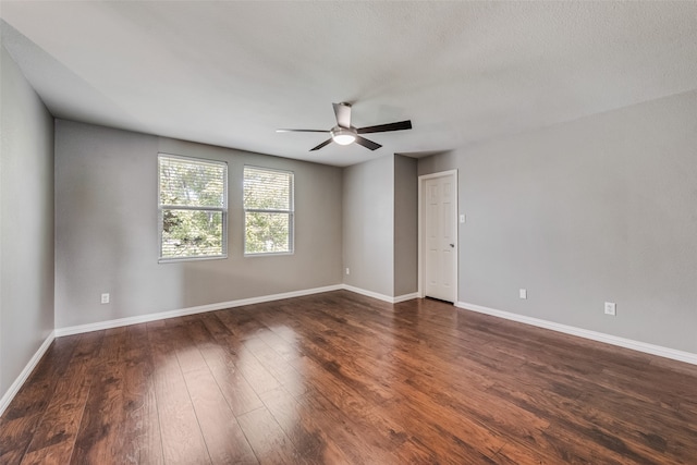 spare room with dark hardwood / wood-style floors and ceiling fan