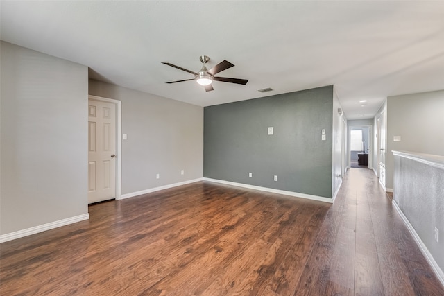 unfurnished room with dark hardwood / wood-style floors and ceiling fan