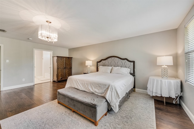 bedroom featuring dark hardwood / wood-style flooring and an inviting chandelier