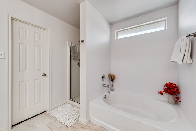 bathroom featuring shower with separate bathtub