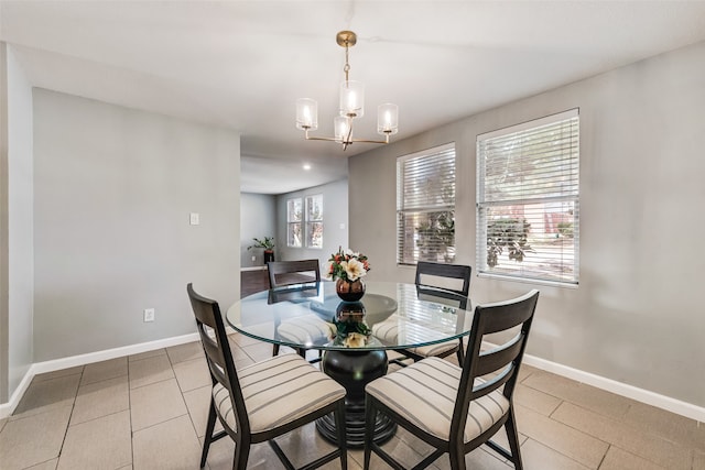 tiled dining space with an inviting chandelier and plenty of natural light