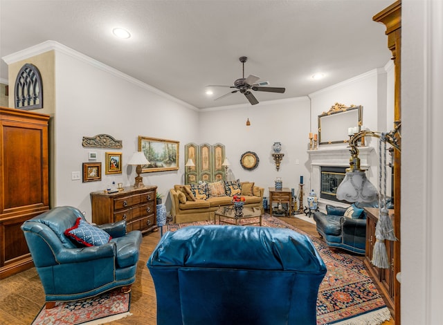 living room featuring crown molding, hardwood / wood-style flooring, and ceiling fan