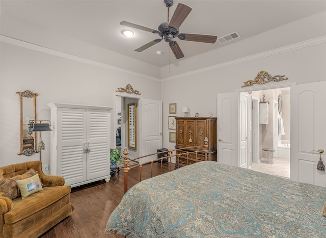 bedroom featuring crown molding, ensuite bathroom, wood-type flooring, and ceiling fan