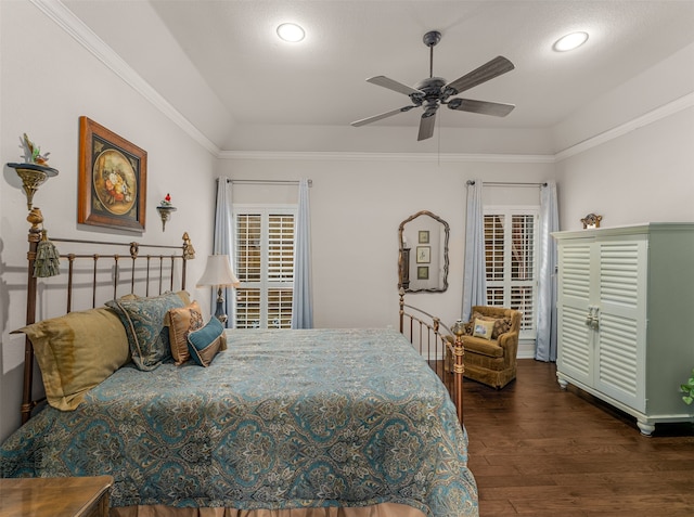 bedroom featuring dark hardwood / wood-style flooring, crown molding, and ceiling fan