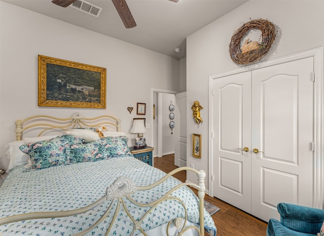 bedroom with a closet, ceiling fan, and dark hardwood / wood-style flooring