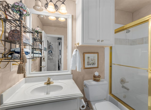 full bathroom featuring vanity, toilet, and combined bath / shower with glass door