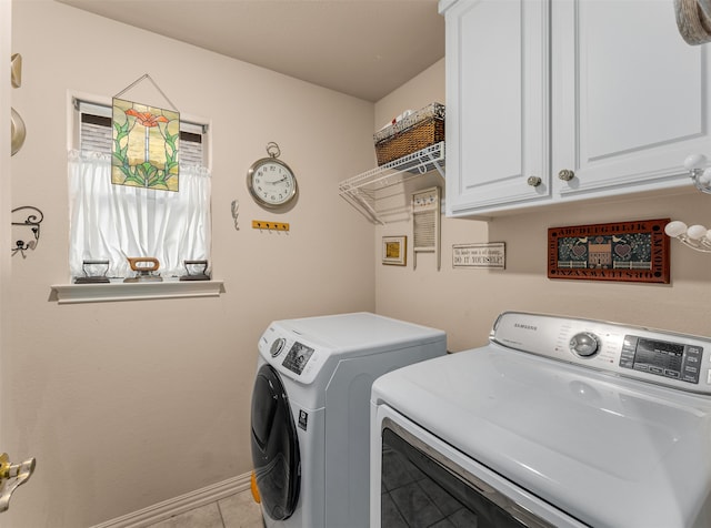 laundry area featuring cabinets, separate washer and dryer, and light tile patterned floors