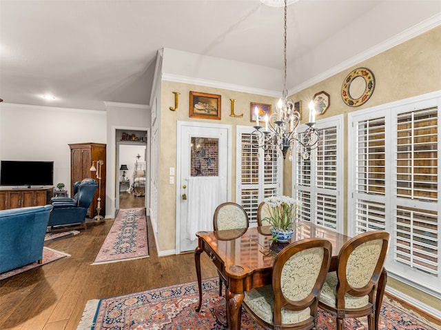 dining room featuring ornamental molding, dark hardwood / wood-style floors, and a chandelier