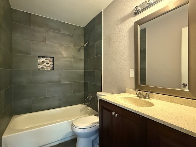 full bathroom with vanity, toilet, and tiled shower / bath