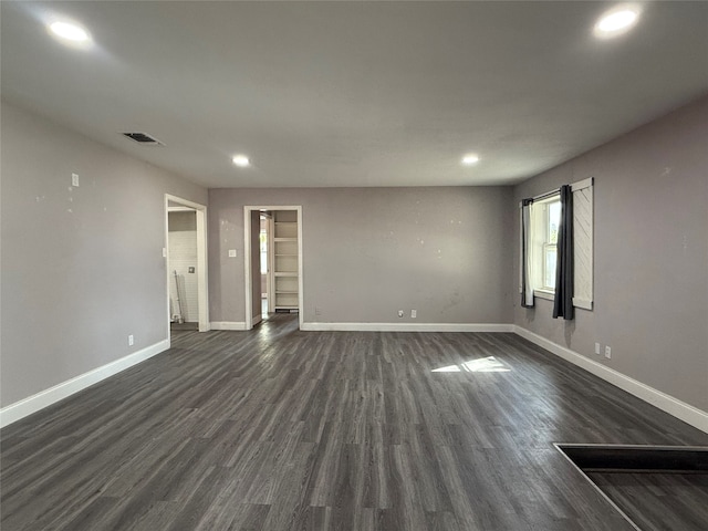 unfurnished room with dark hardwood / wood-style flooring