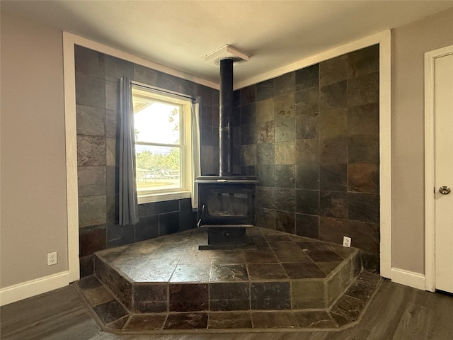 bathroom featuring a wood stove and wood-type flooring