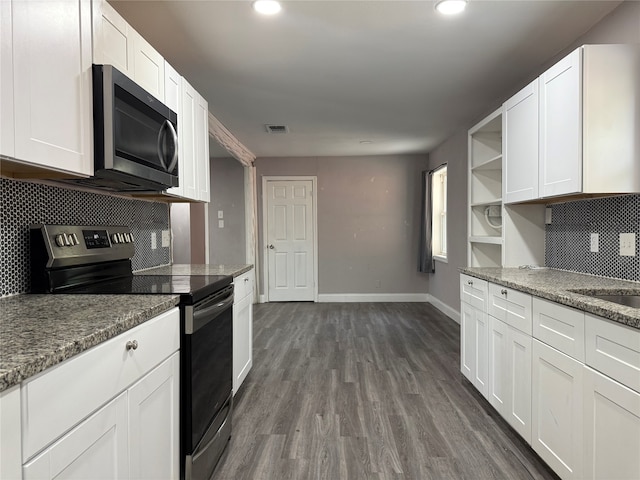 kitchen with light stone counters, backsplash, white cabinetry, dark hardwood / wood-style floors, and stainless steel appliances