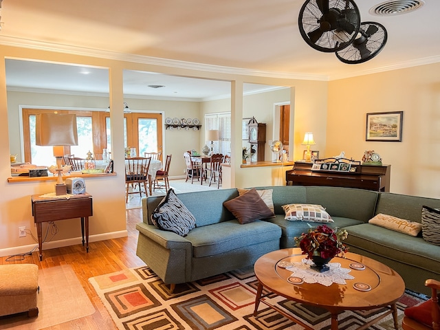 living room featuring ornamental molding and light wood-type flooring