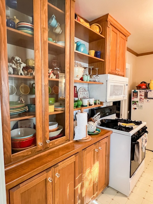 kitchen with crown molding and white appliances