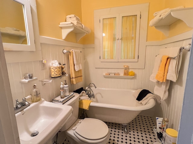 bathroom with toilet, sink, and a bathtub