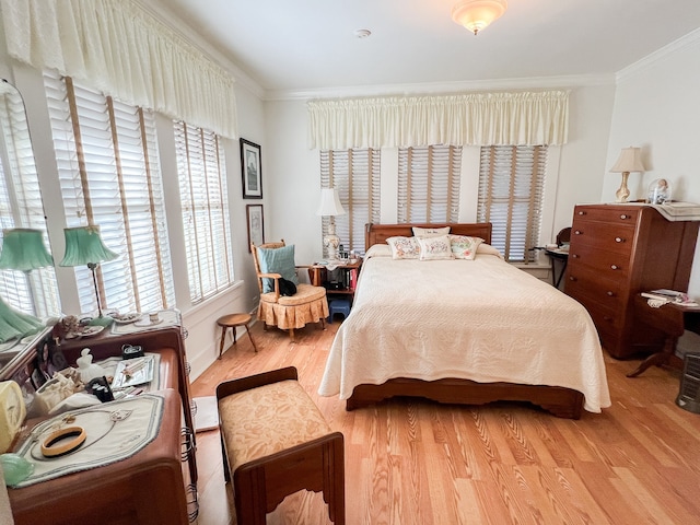 bedroom with crown molding and hardwood / wood-style floors