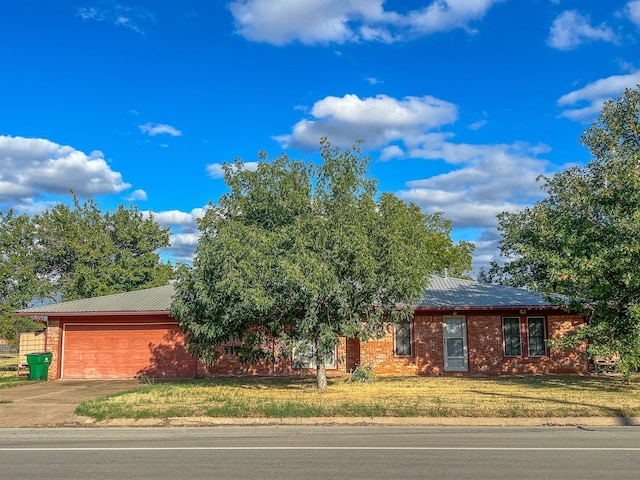 view of front of property featuring a front yard and a garage