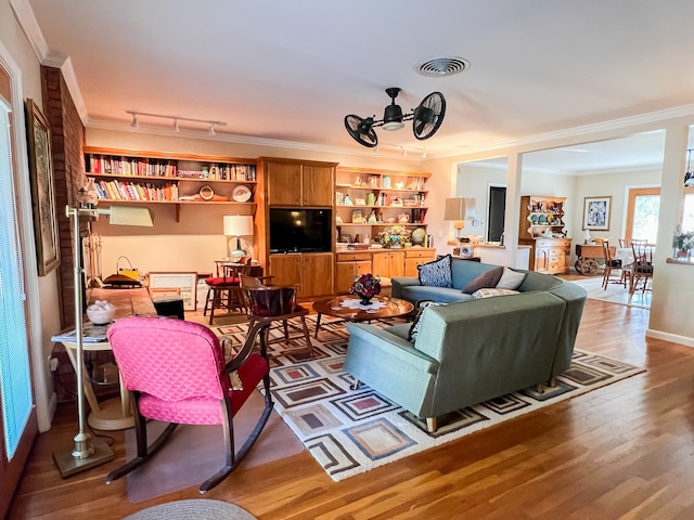 living room featuring ceiling fan, crown molding, and hardwood / wood-style floors