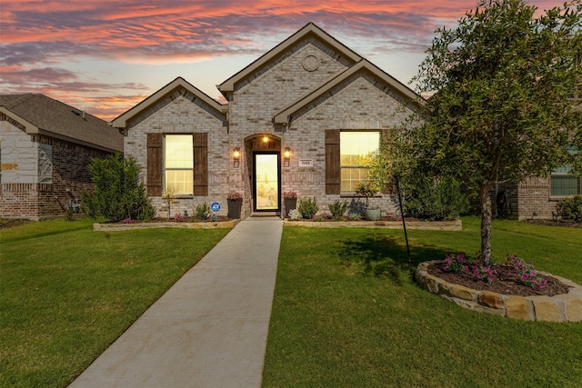 french provincial home featuring a lawn