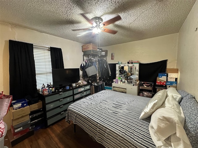 bedroom with a textured wall, a textured ceiling, wood finished floors, and a ceiling fan
