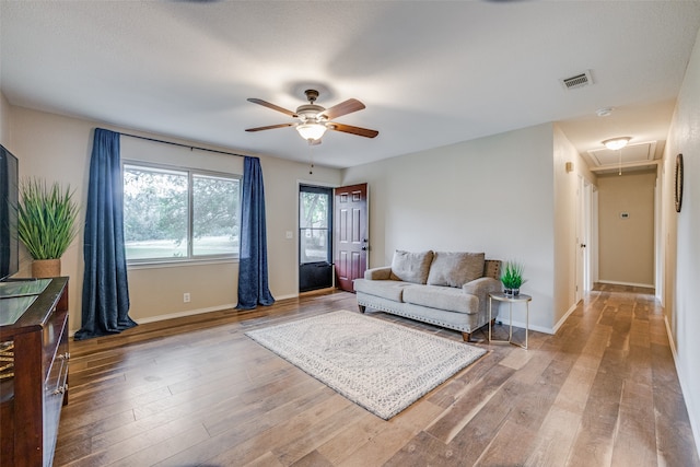 living room featuring hardwood / wood-style flooring and ceiling fan