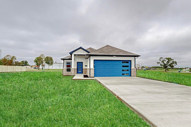 view of front of property featuring a garage and a front lawn