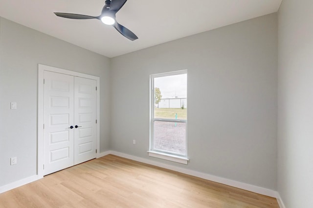 unfurnished bedroom with a closet, ceiling fan, and light wood-type flooring