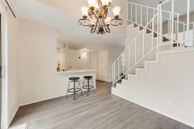 interior space featuring wood-type flooring and a notable chandelier