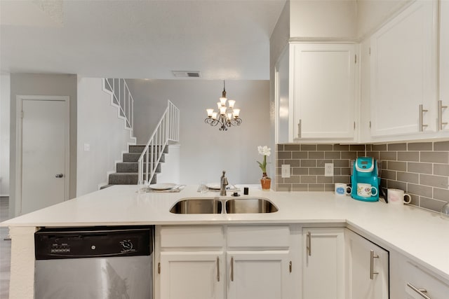 kitchen featuring sink, kitchen peninsula, stainless steel dishwasher, white cabinets, and pendant lighting