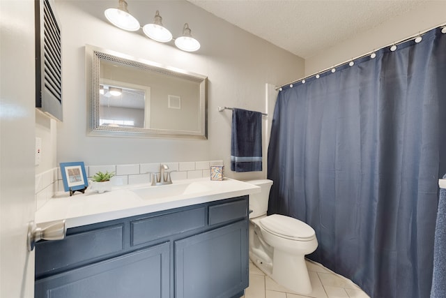 bathroom featuring vanity, tile patterned floors, toilet, and a textured ceiling