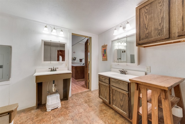 bathroom featuring electric panel, sink, and a textured ceiling