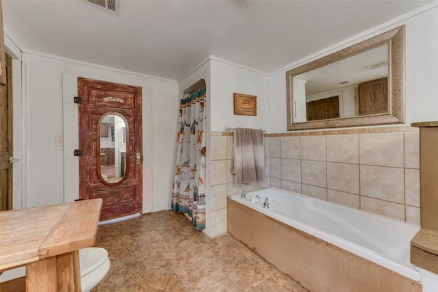 bathroom with toilet, tile walls, ornamental molding, and tiled tub