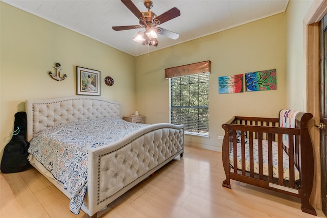 bedroom featuring light hardwood / wood-style flooring and ceiling fan