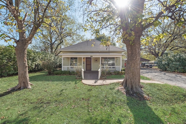 view of front of home with a porch and a front yard