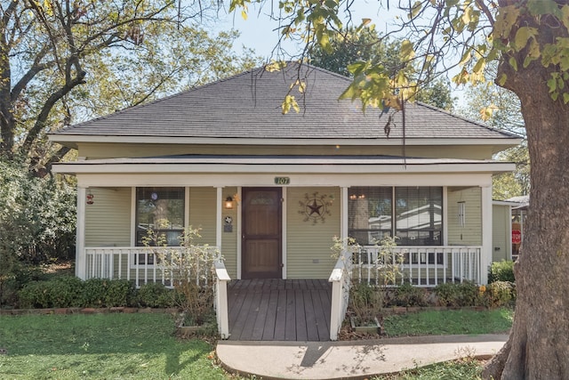 bungalow-style house with a front lawn and a porch