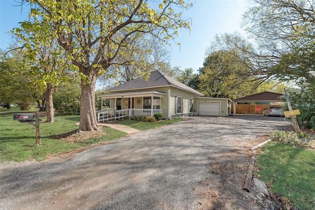 view of front of house with a front lawn, a porch, and a garage