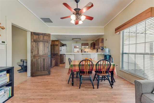 dining area featuring light wood-type flooring and ceiling fan