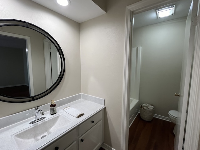 bathroom with vanity, wood-type flooring, and toilet