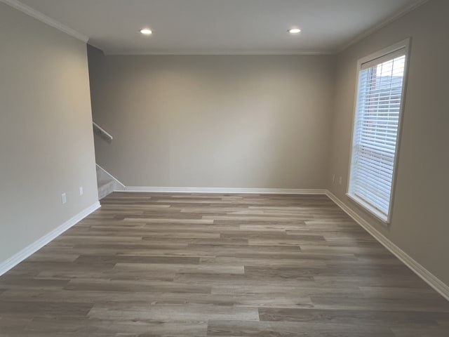 spare room with hardwood / wood-style floors and ornamental molding