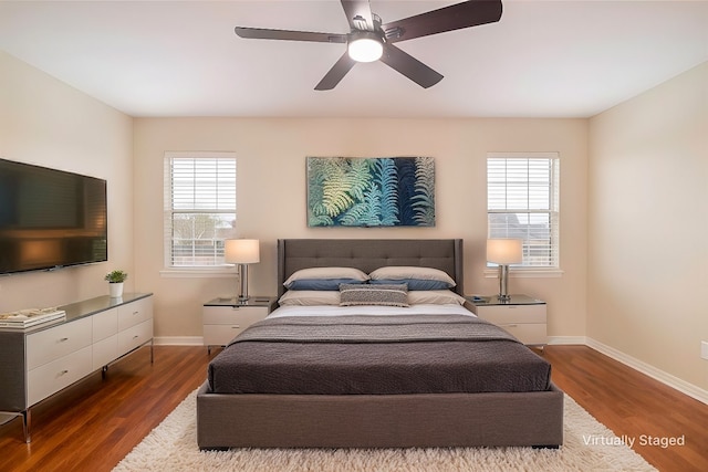 bedroom with ceiling fan and dark wood-type flooring