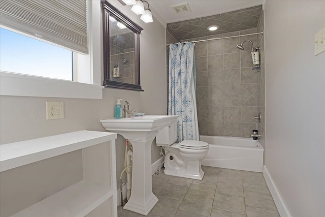 bathroom with tile patterned floors, toilet, and shower / tub combo with curtain