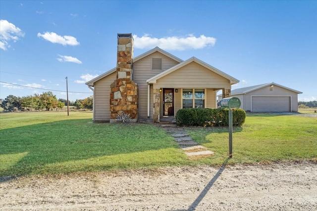 view of front of home with covered porch, a garage, an outdoor structure, and a front lawn